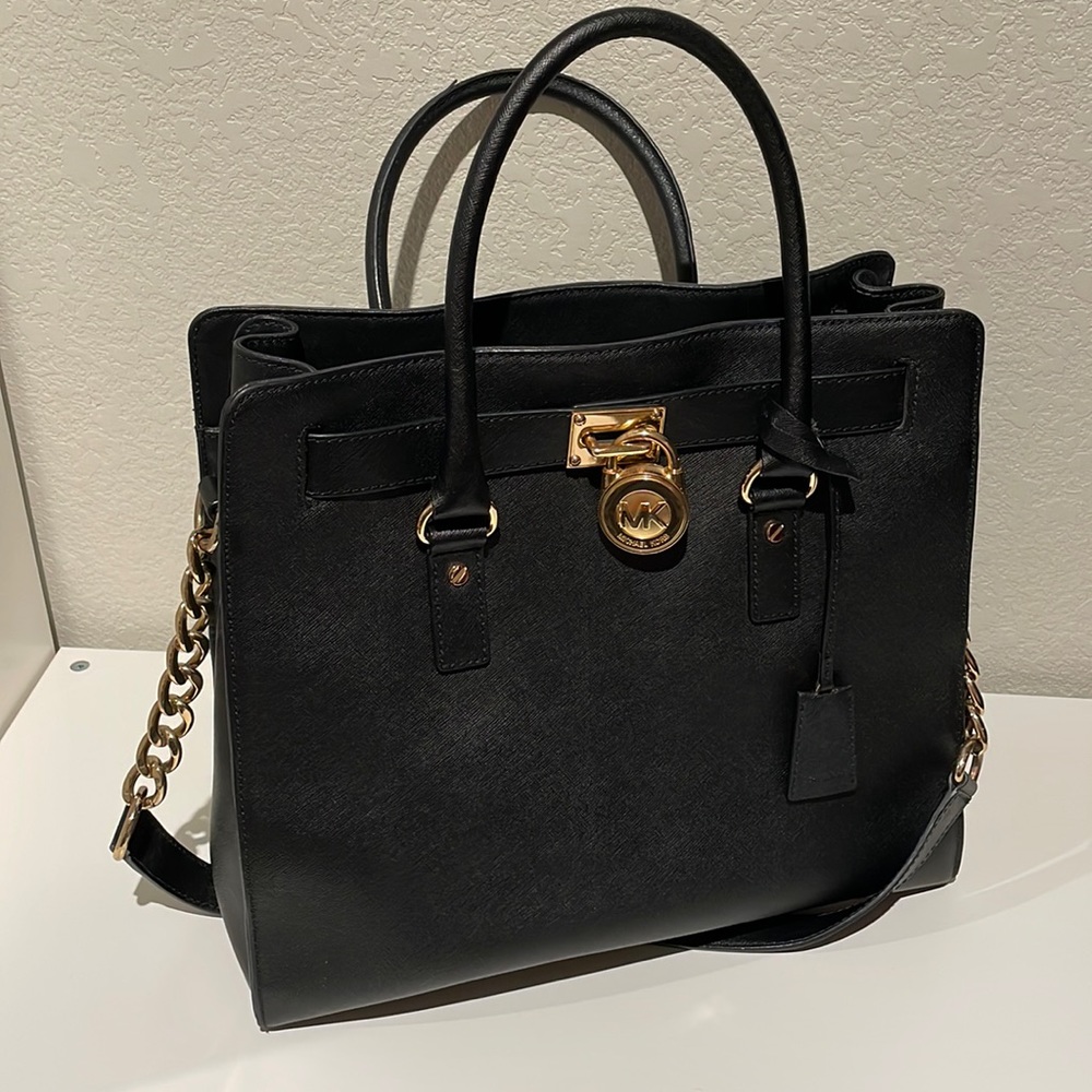 Michael Kors tote bag with top handles and shoulder strap with chain.